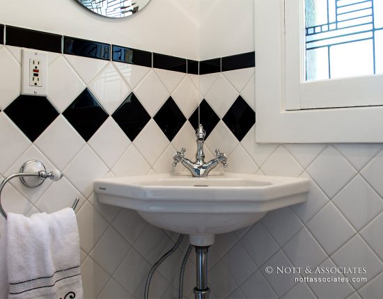 A powder room with period style corner sink