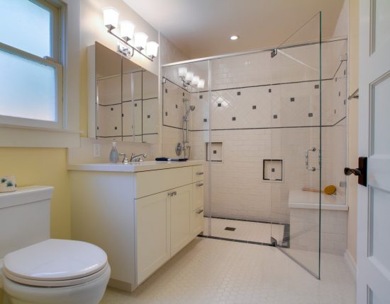 A frameless glass shower for ADA accessibility.