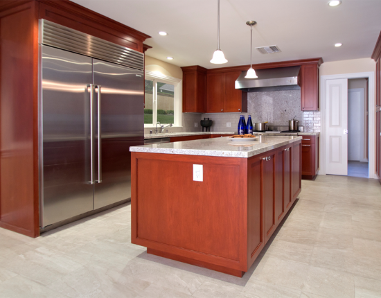 Cherry kitchen with light grey flooring and tile.