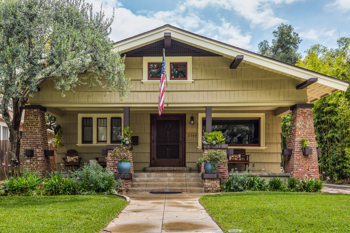 Restored Craftsman With Exposed Brick Columns And Accented Wood Work