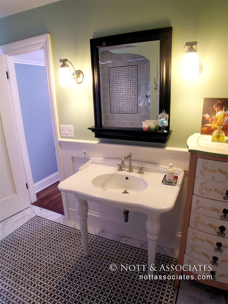 A period style pedestal sink and mosaic pattern floor. - Nott & Associates