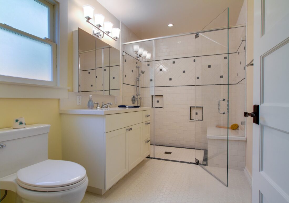 Bathroom remodel with frameless glass shower for ADA accessibility.