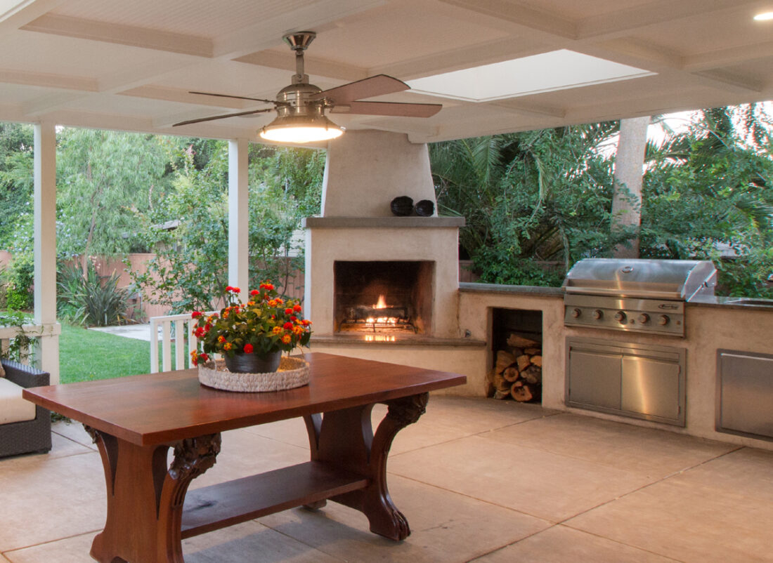 Outdoor entertainment area with wood burning fireplace, BBQ, skylights and stone countertops