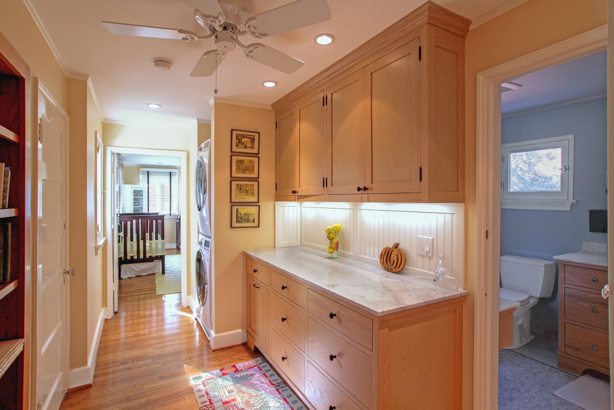 2nd floor laundry area with cabinetry storage.
