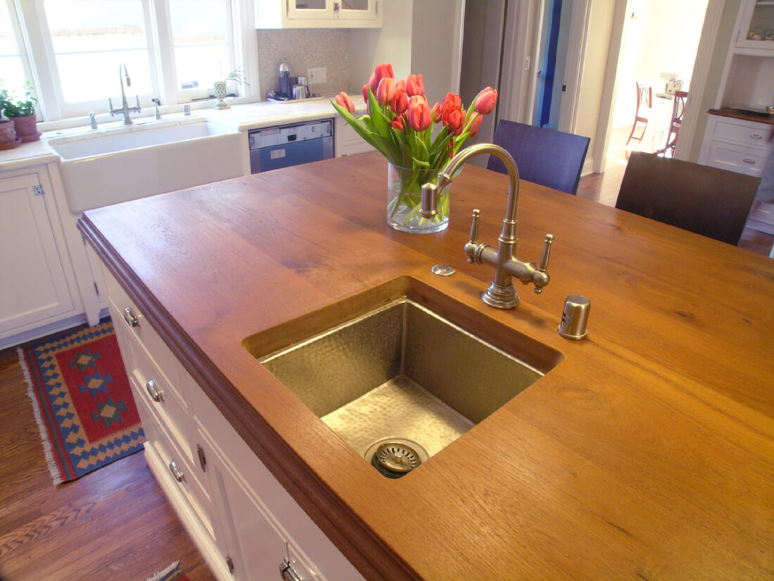 Kitchen island featuring a Teak wood countertop