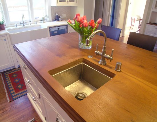 Kitchen island featuring a Teak wood countertop