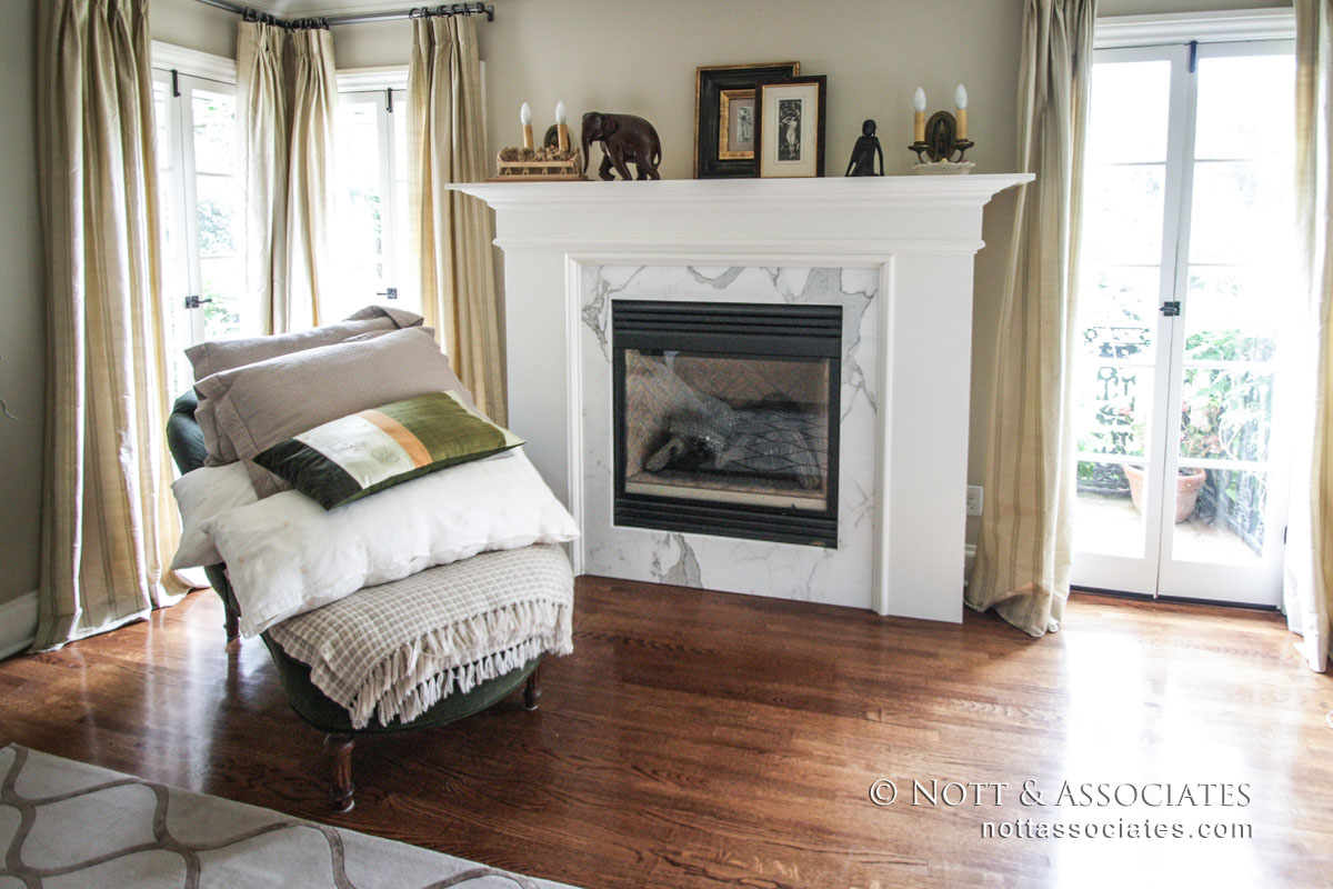 Marble & Wood Surrounding Fireplace in Bedroom