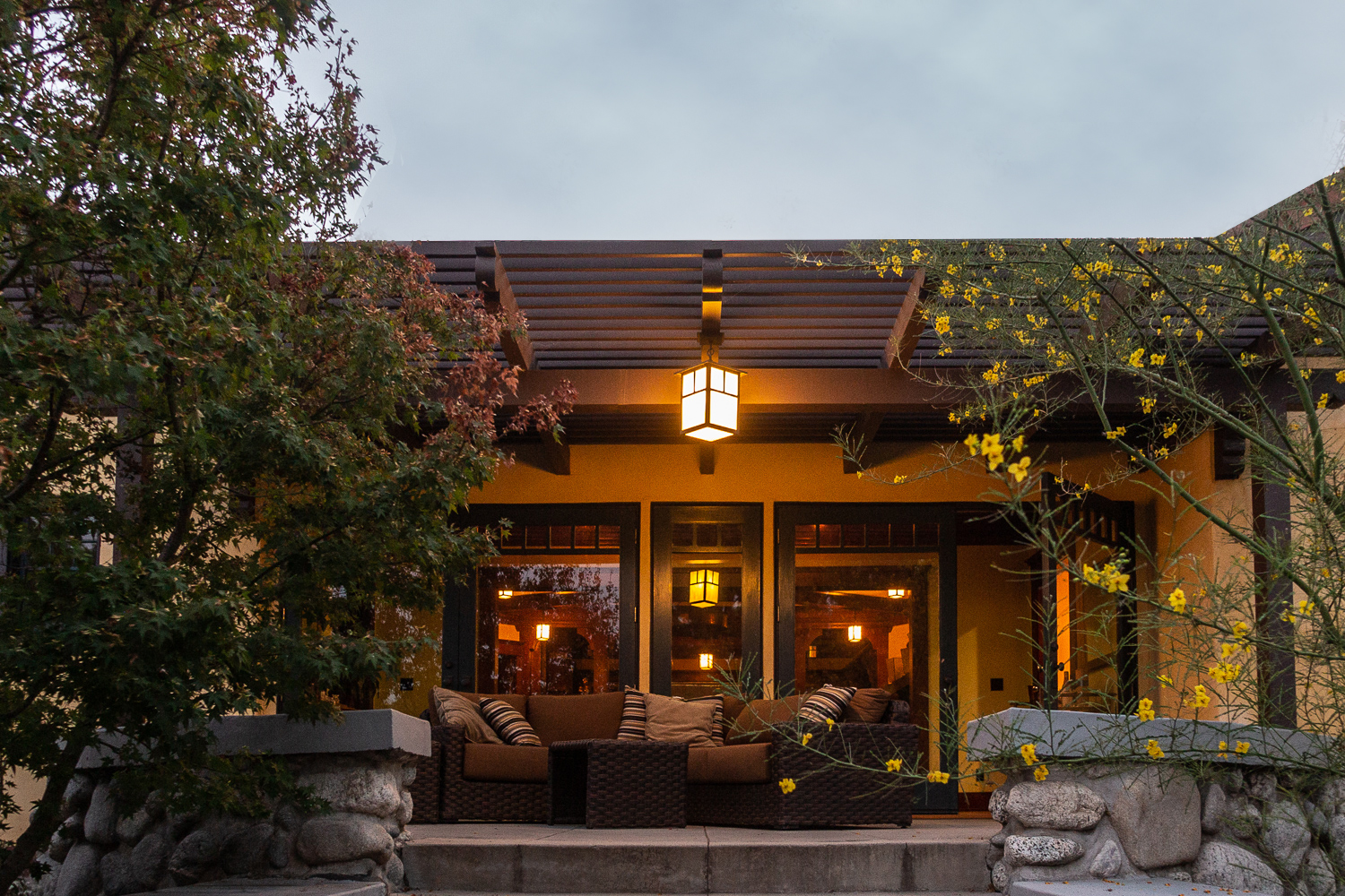 Backyard patio with custom lighting and outdoor furniture