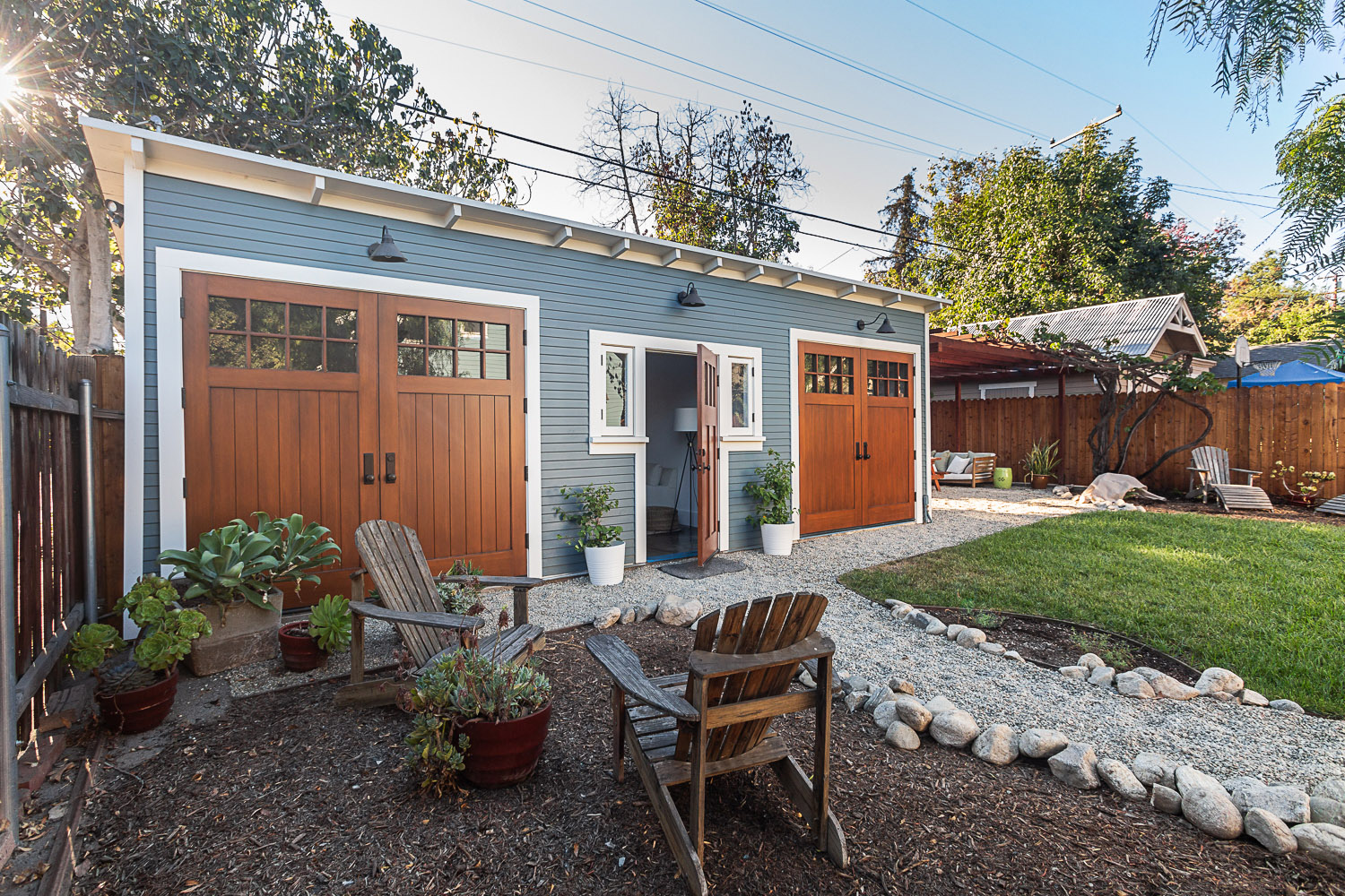 Restored Craftsman garage with comfortable outdoor living space.