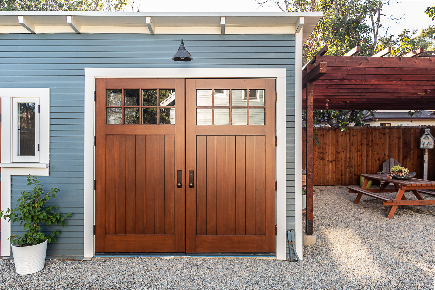 Restored Craftsman garage with comfortable outdoor living space.