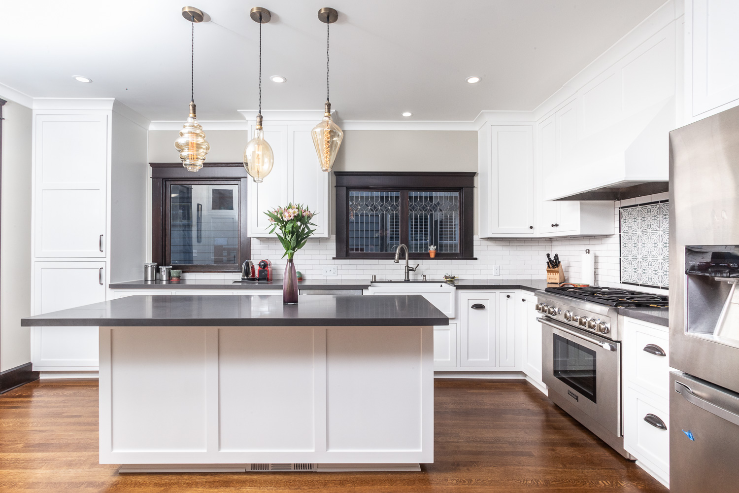 Pasadena kitchen remodel featuring reproduction light fixtures over ample island workspace