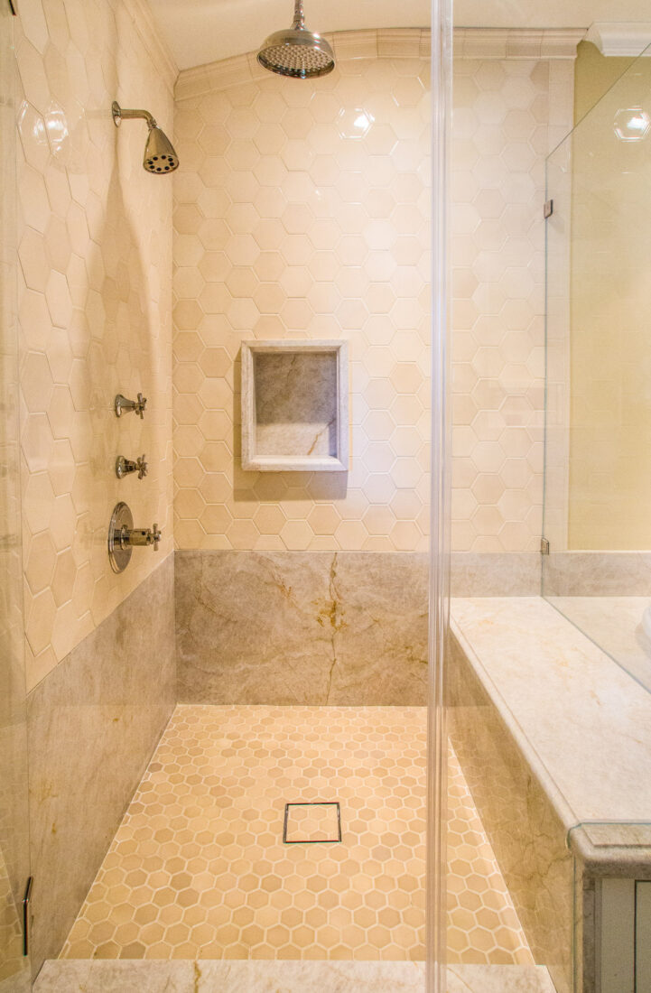 A Frameless Glass Shower Remodeled With Full Bench And Rain Shower Head-
