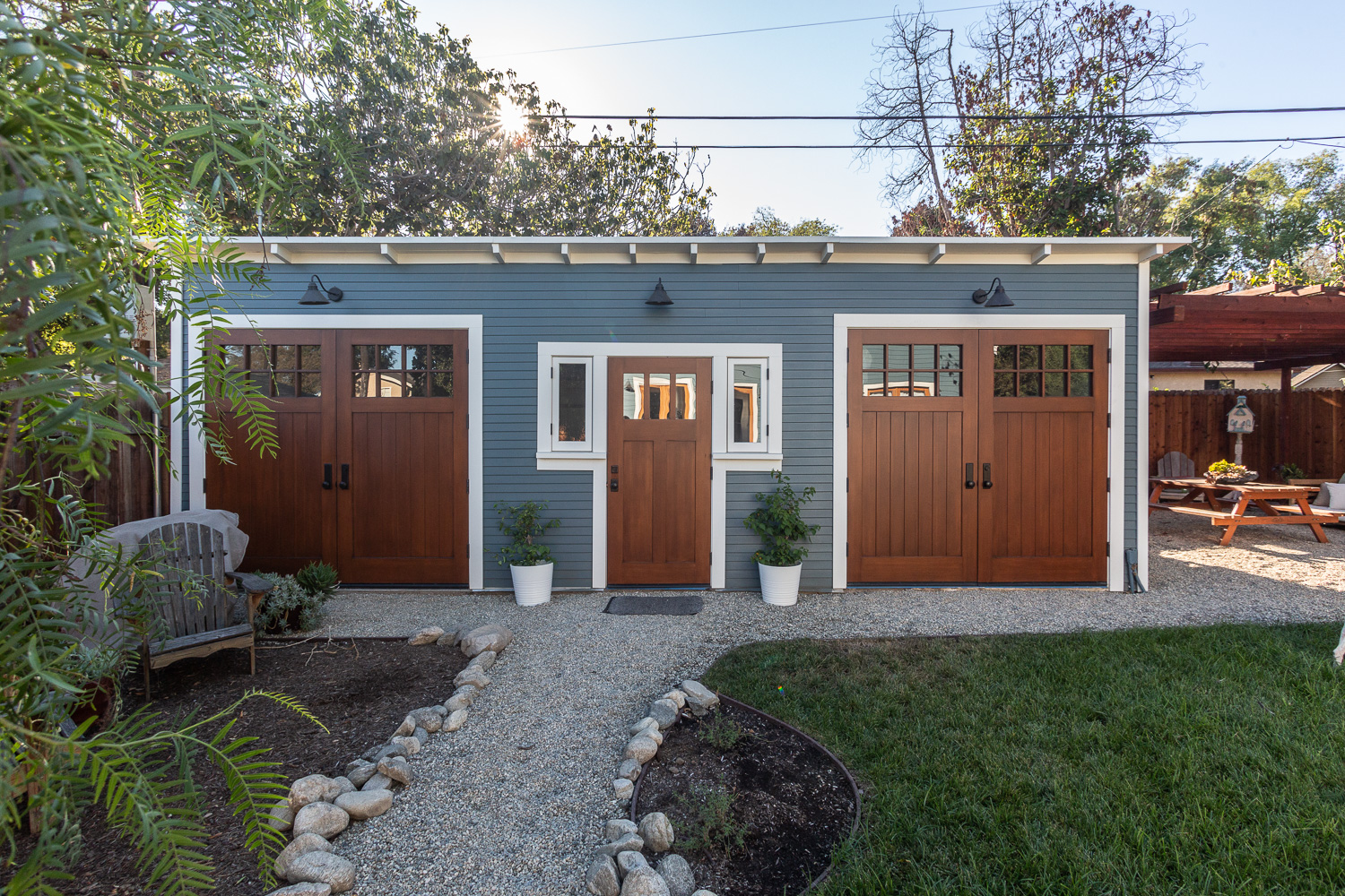 Restored Craftsman garage with comfortable outdoor living space.