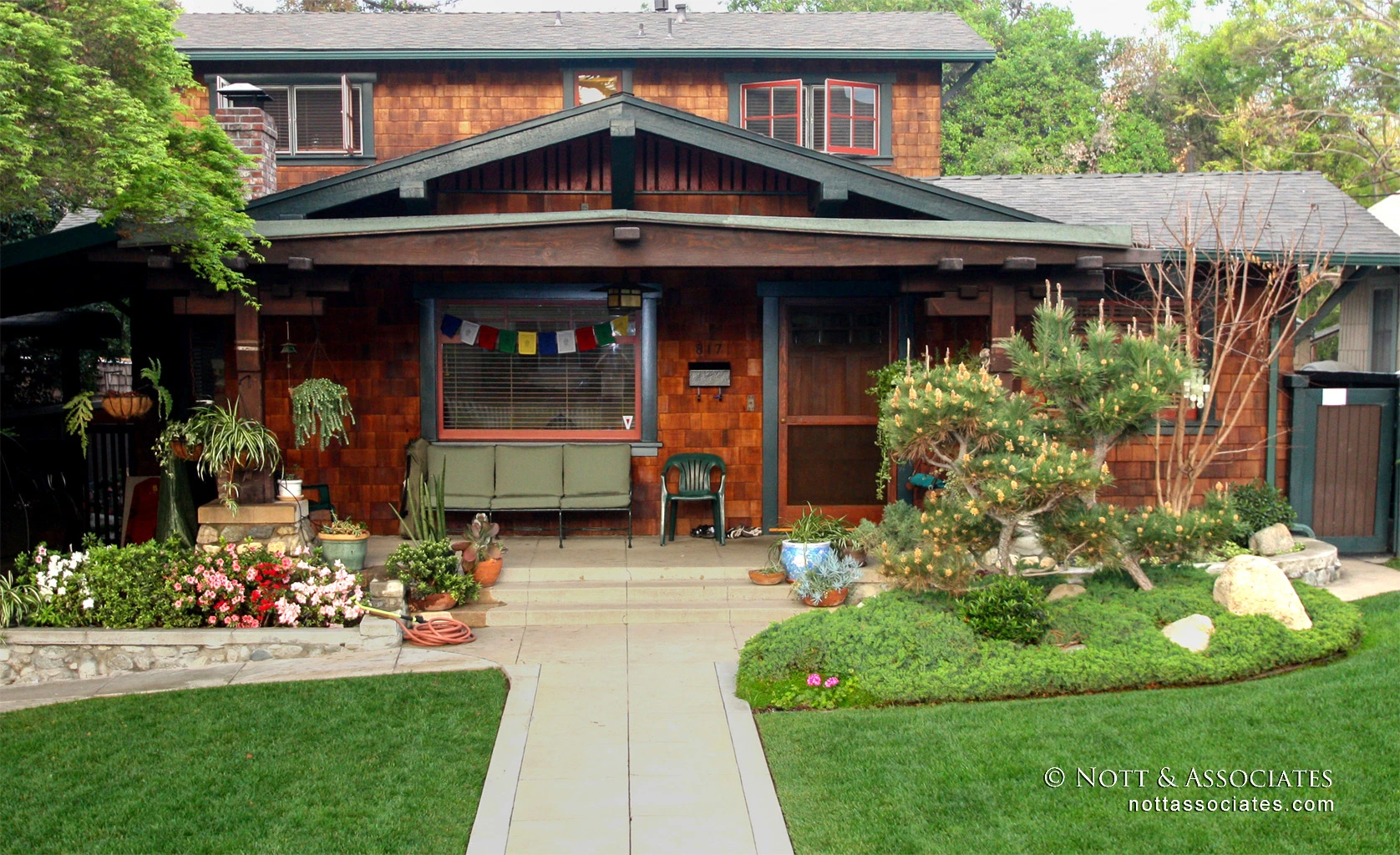 After photo of a restored craftsman home with an added second story and new siding.