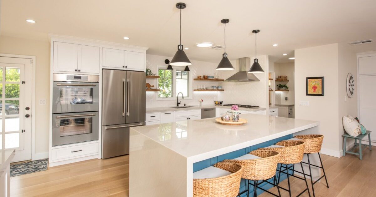 San Marino kitchen with marble island, hanging light fixtures, and luxury detailing.