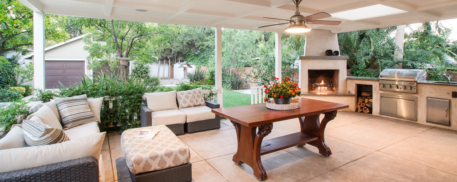 Outdoor living space with seating, outdoor fireplace, and outdoor kitchen
