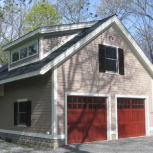 Custom three bay, story-and-a-half garage with red doors.
